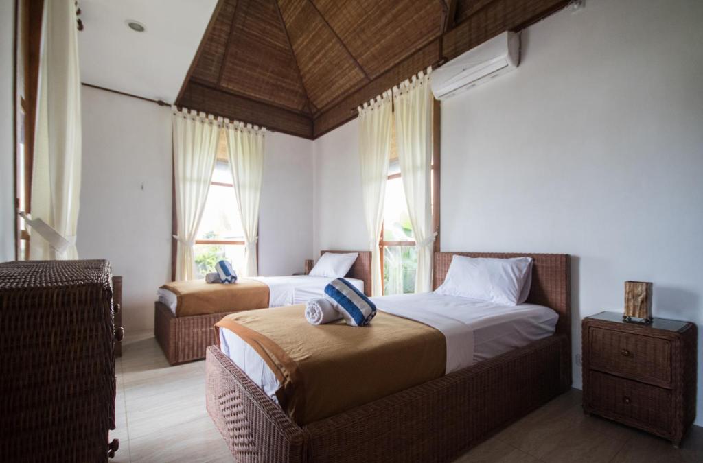 Postel nebo postele na pokoji v ubytování Medewi Beachfront Getaway