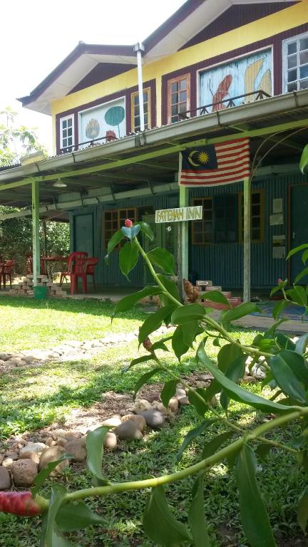 a house with an american flag on it at Fatehah Inn in Kuala Tahan