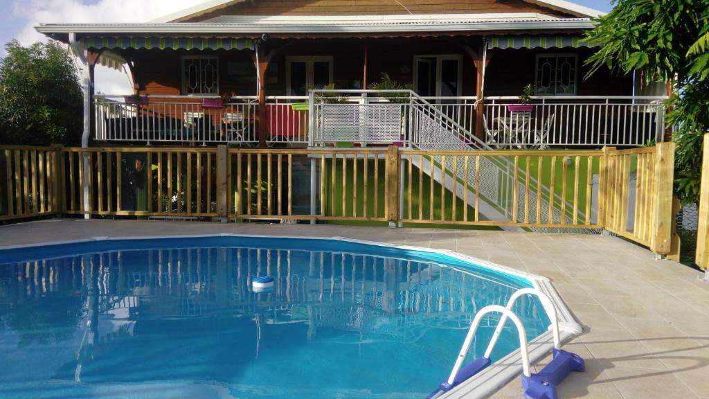 a swimming pool in front of a house at Gîtes Soussoune in Anse-Bertrand