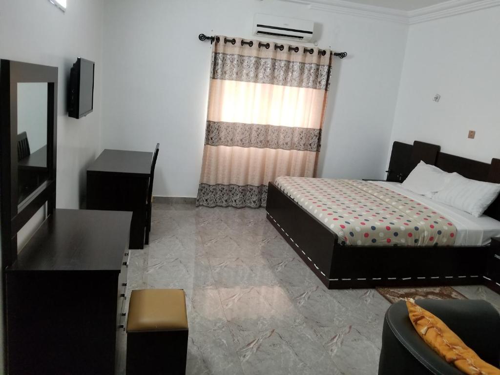 Ένα ή περισσότερα κρεβάτια σε δωμάτιο στο Ragaray Executive Suites