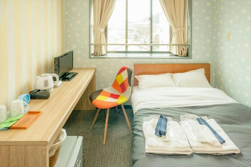 Llit o llits en una habitació de Hotel Ina
