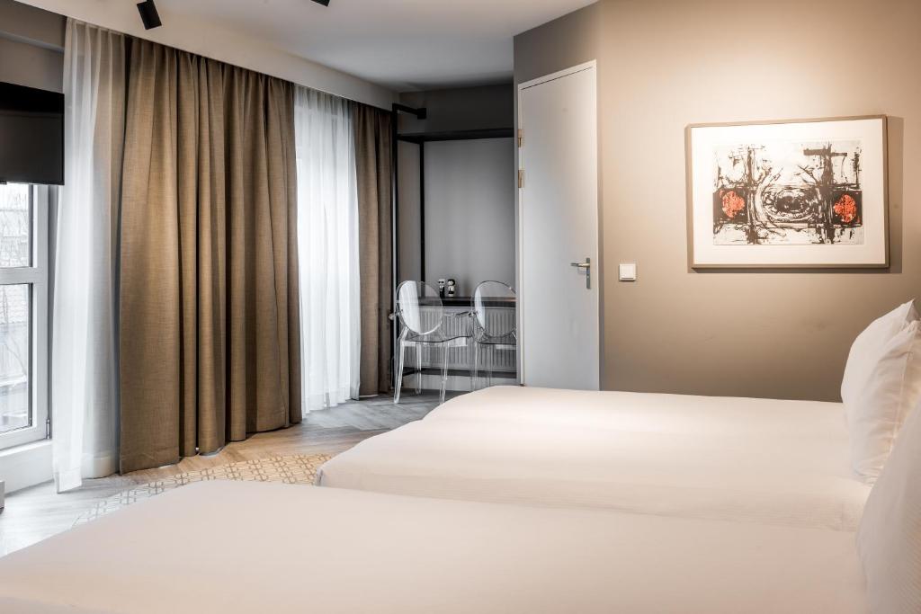Postel nebo postele na pokoji v ubytování Sandton Eindhoven Centre