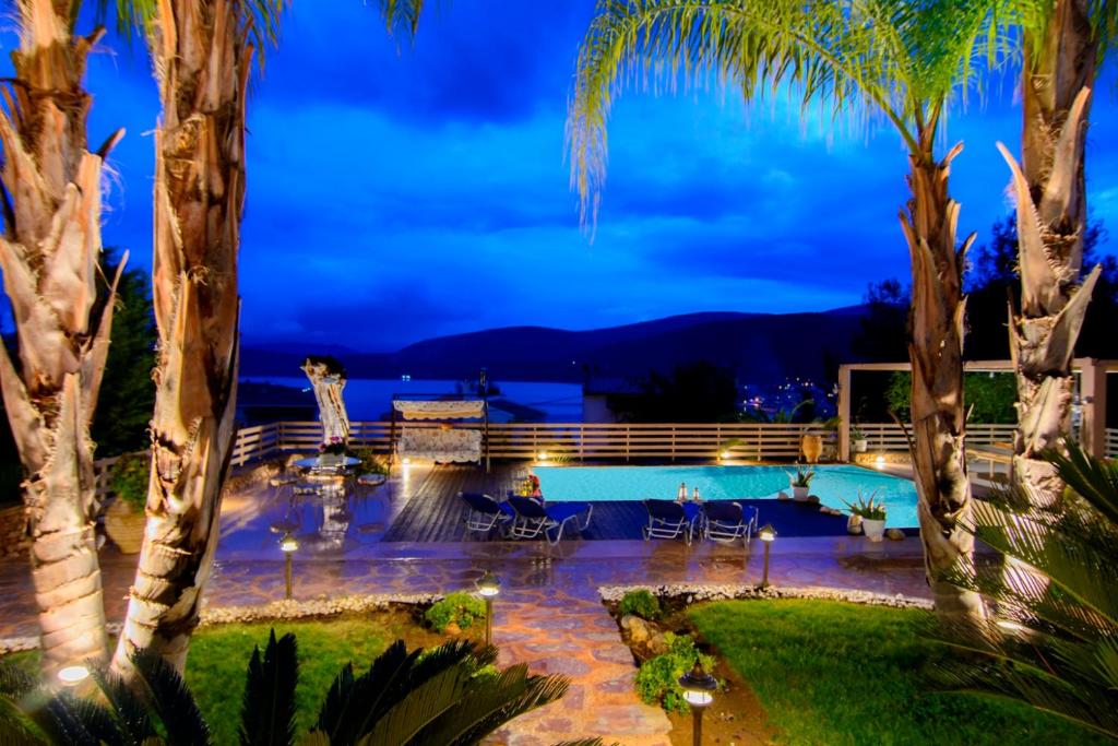 a villa with a swimming pool at night at Villa Maira Luxurious with private swimming pool in Korfos