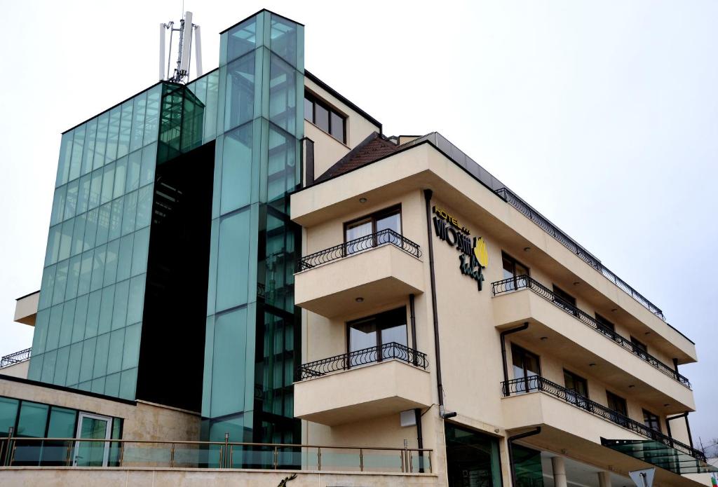 um edifício com um edifício de vidro em Vitoshko Lale Hotel em Sófia