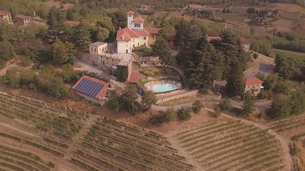 an aerial view of a house with a swimming pool at Castello di Grillano Guest House in Ovada