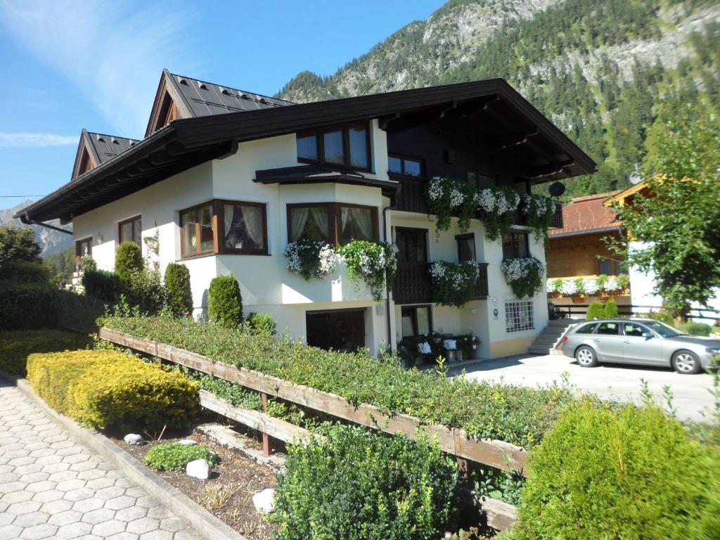 a house with a car parked in front of it at Appartement Koller in Pertisau