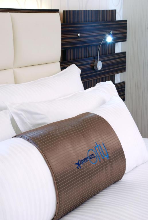 a bed with a mattress with the anaheim logo on it at Orty Airport Hotel in Izmir
