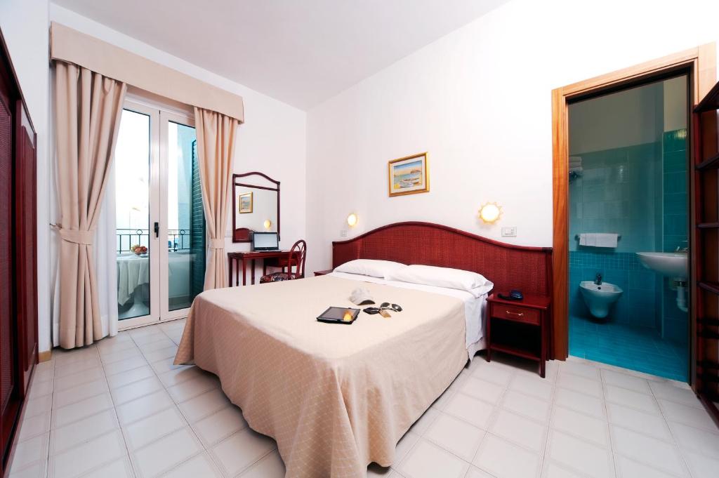 Postel nebo postele na pokoji v ubytování Hotel Ulisse
