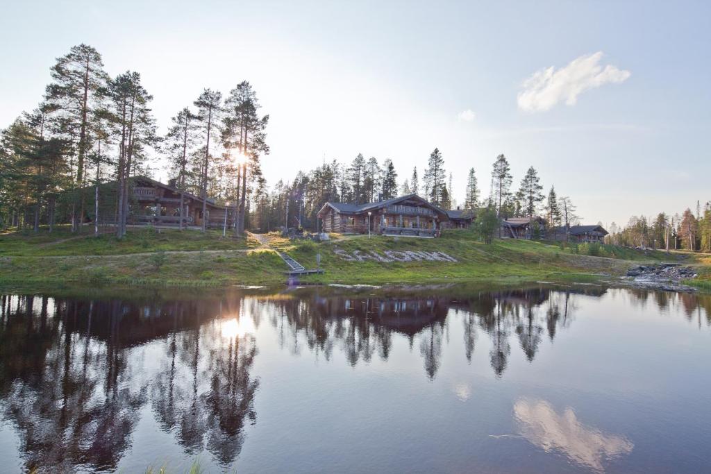 a house on a hill next to a lake at Rukan Salonki Resort in Ruka