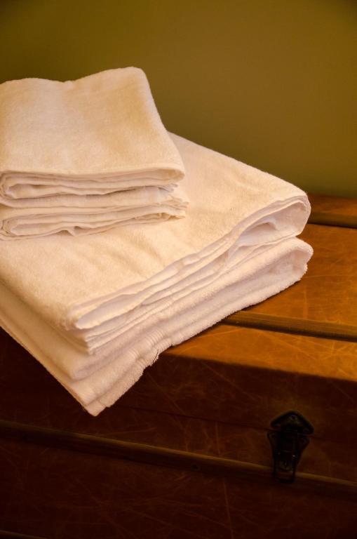 a stack of towels sitting on top of a dresser at The Carrick in Portrush
