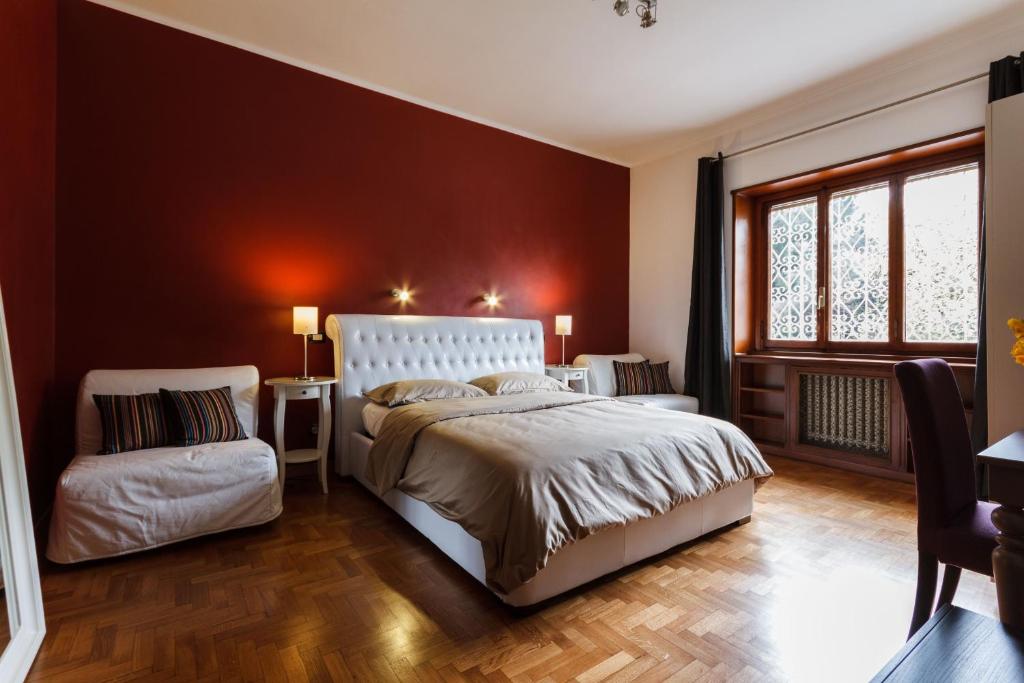 a bedroom with a large bed and a window at L'Angolo Cortese in Rome