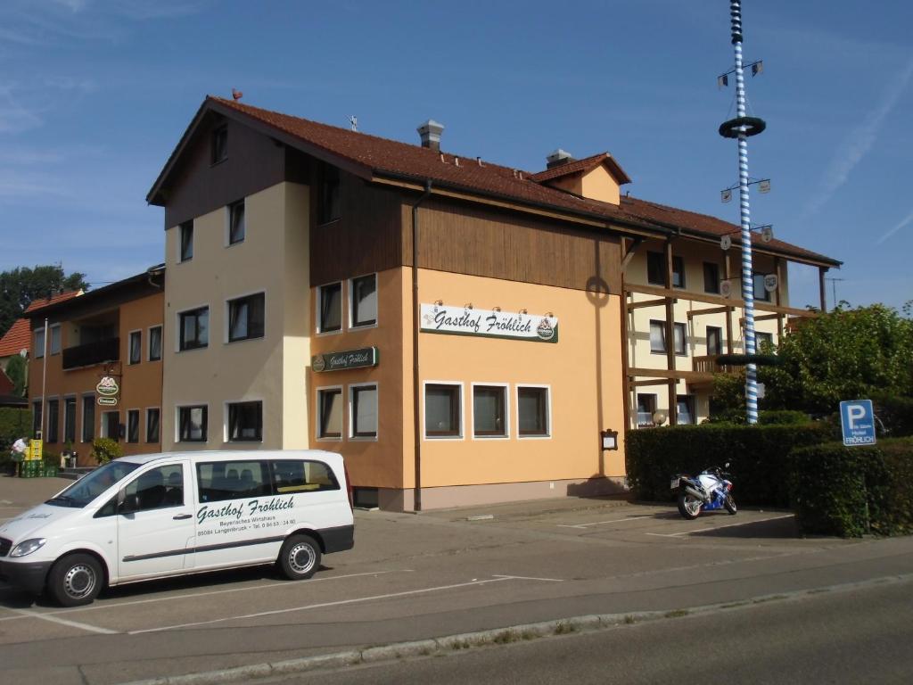 a white van parked in front of a building at Gasthof Fröhlich in Langenbruck