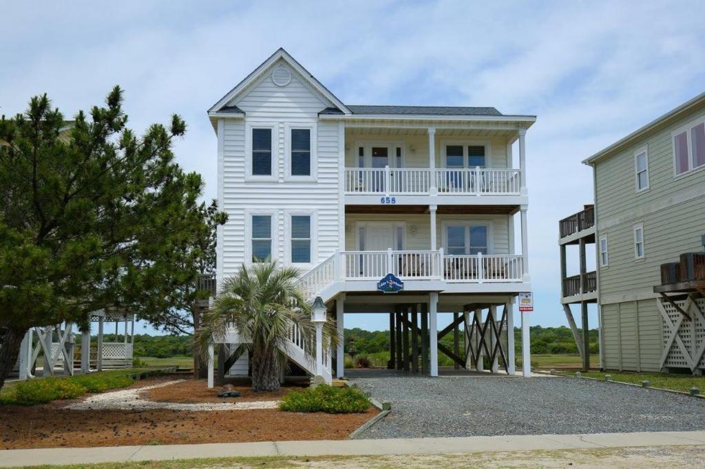a large white house with a large porch at Libby's Lookout in Holden Beach