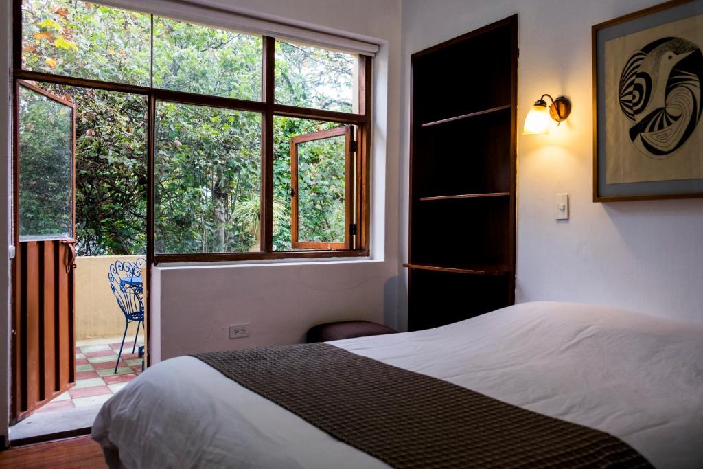 Postel nebo postele na pokoji v ubytování Hostal Posada del Maple