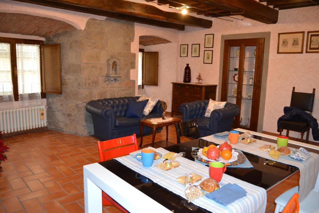 a living room with couches and a table with food on it at Sweet Cortona in Cortona