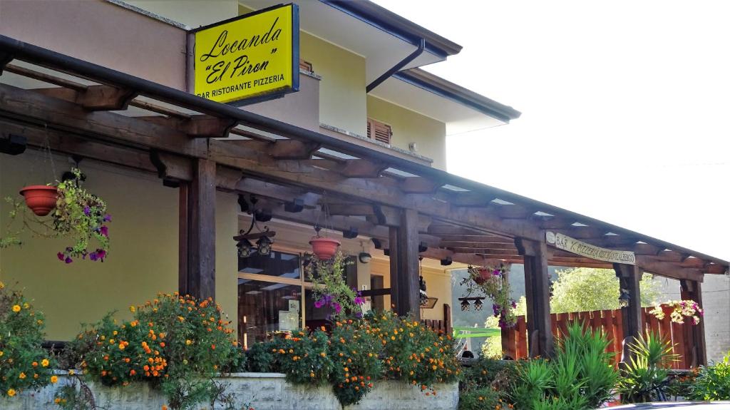 a building with a sign on the side of it at Locanda El Piron in Chiampo