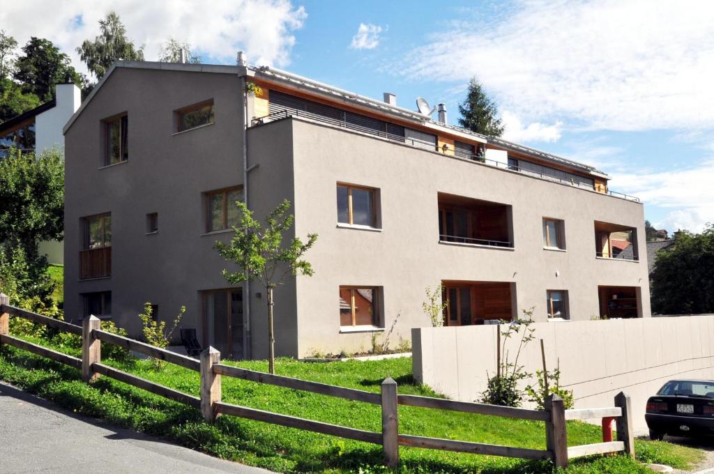 a building with a fence in front of it at Crastuoglia 720 - Nr. 1 in Scuol