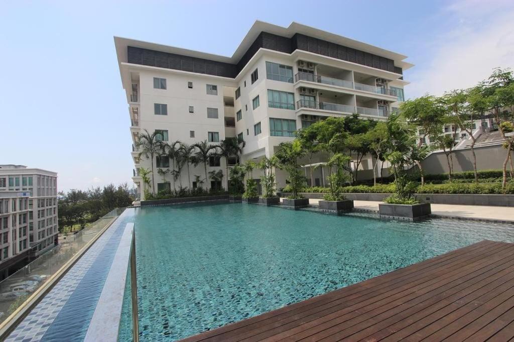 a swimming pool in front of a building at The Loft Imago in Kota Kinabalu