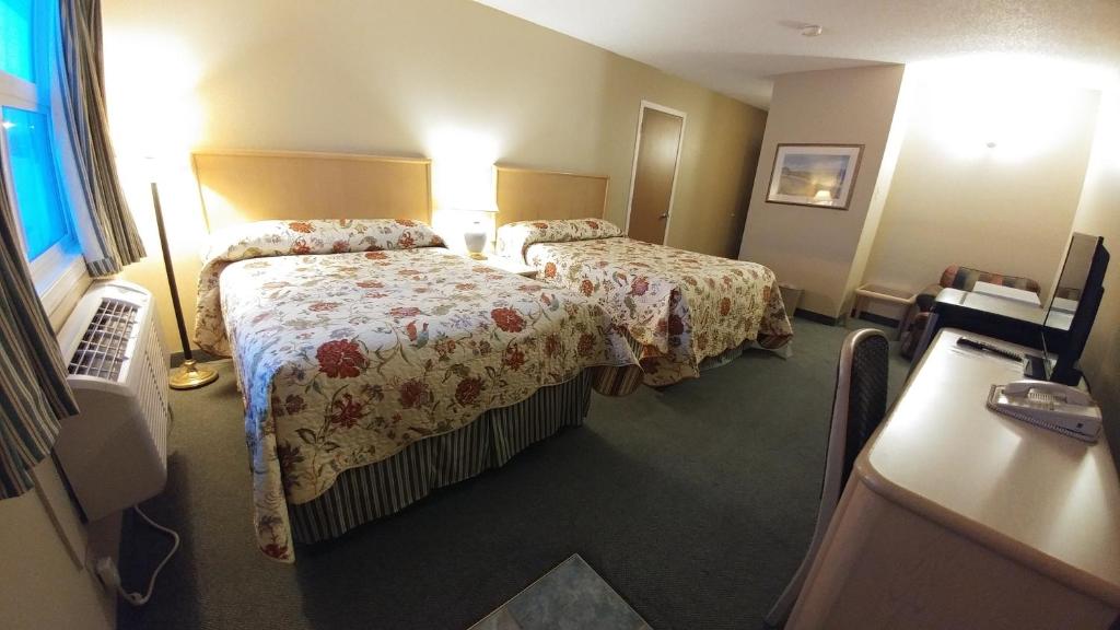 A bed or beds in a room at Vulcan Country Inn