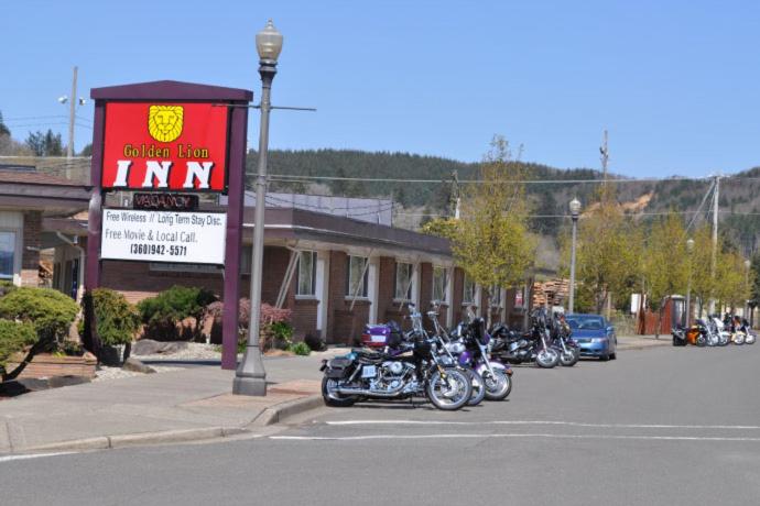 a group of motorcycles parked in front of a motel at Golden Lion Motel in Raymond