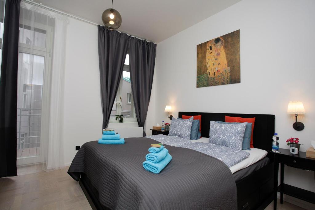布拉格的住宿－斯帕萊納豪華公寓，一间卧室配有两张床和蓝色毛巾。