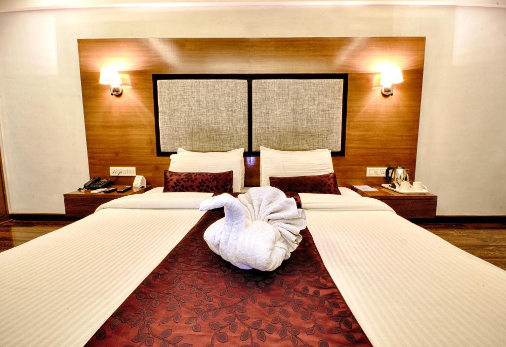 Postel nebo postele na pokoji v ubytování Hotel Platinum Residency