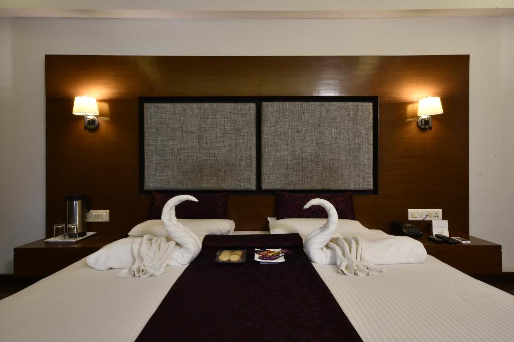 Postel nebo postele na pokoji v ubytování Hotel Platinum Residency