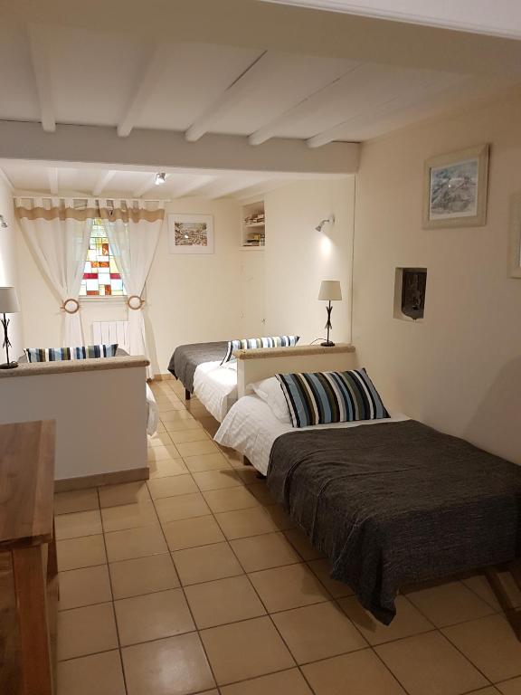 Postel nebo postele na pokoji v ubytování Villa Thebaïde Chambres d'hôtes