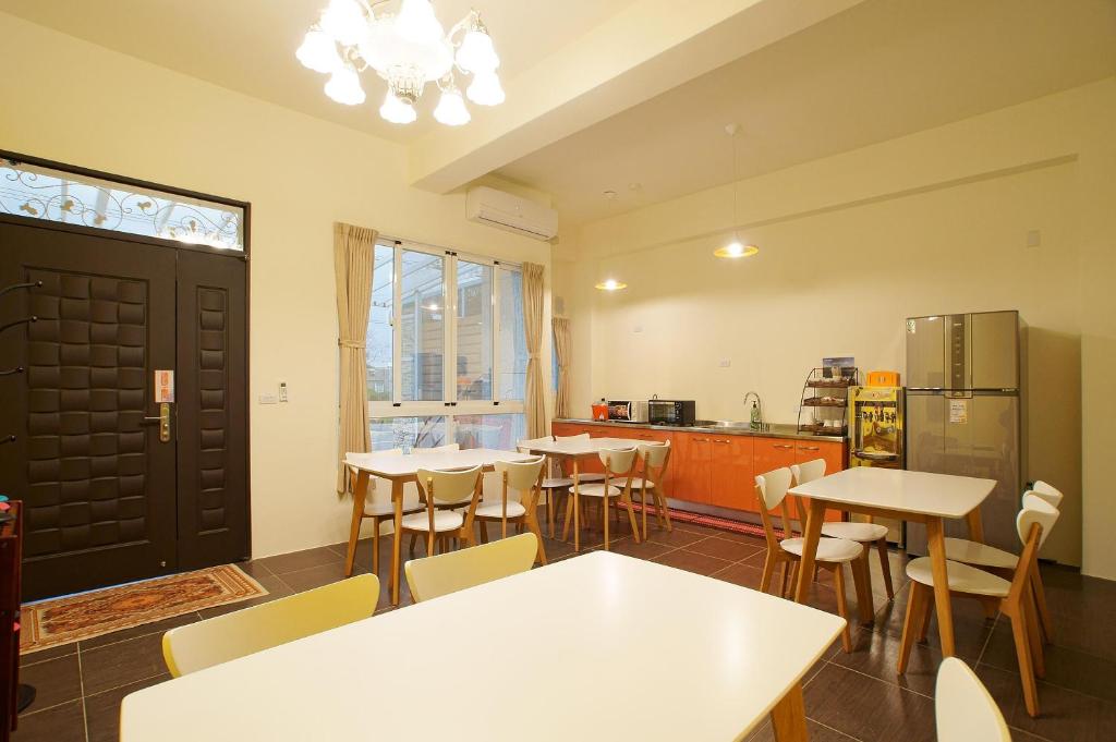 台東市的住宿－輕旅村-陽光輕旅（電梯民宿），带桌椅的房间和厨房