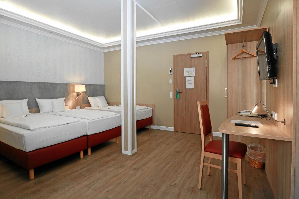 Postel nebo postele na pokoji v ubytování Hotel Danner