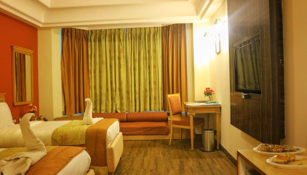 Postel nebo postele na pokoji v ubytování Dee Marks Airport Hotel & Resorts