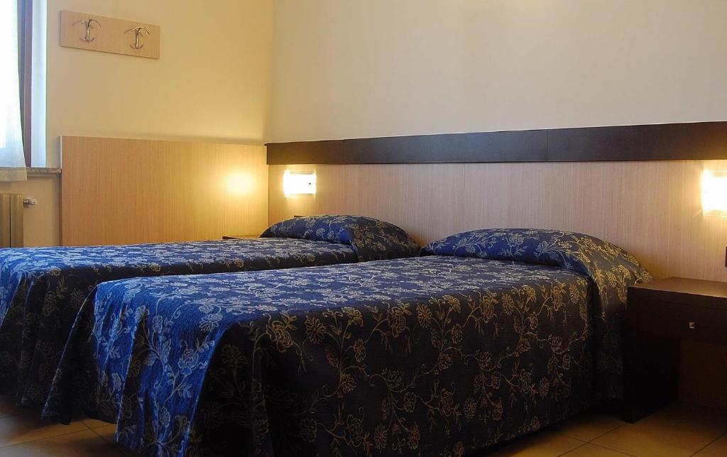 Postel nebo postele na pokoji v ubytování Albergo Visconti