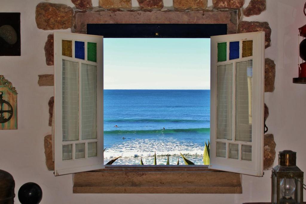an open window with a view of the ocean at Villa Ana Margarida Beach in Ericeira