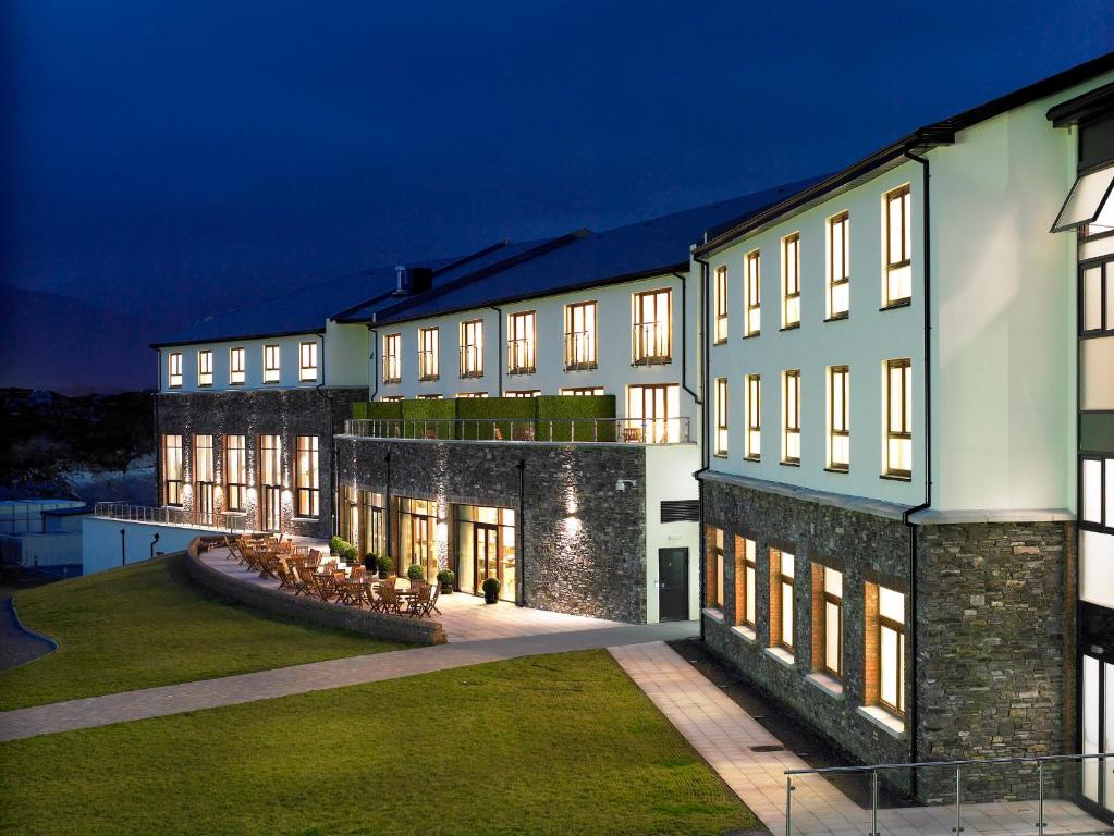 a large building with a courtyard at night at Sneem Hotel in Sneem