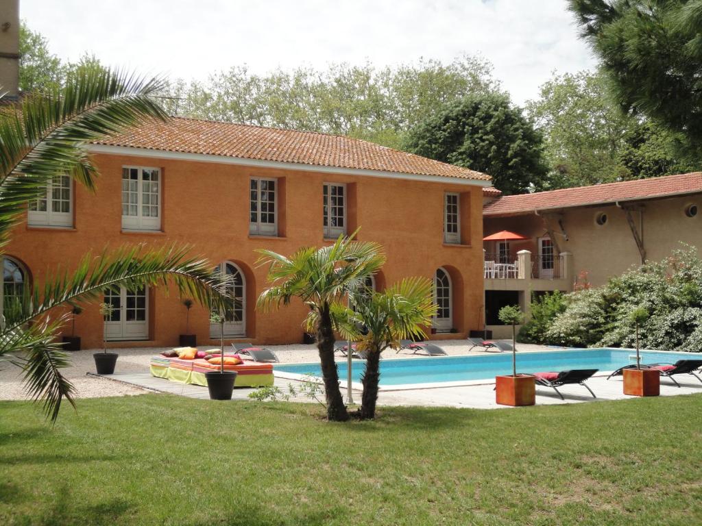 a house with a swimming pool in front of it at La Gourgasse Vieille in Béziers