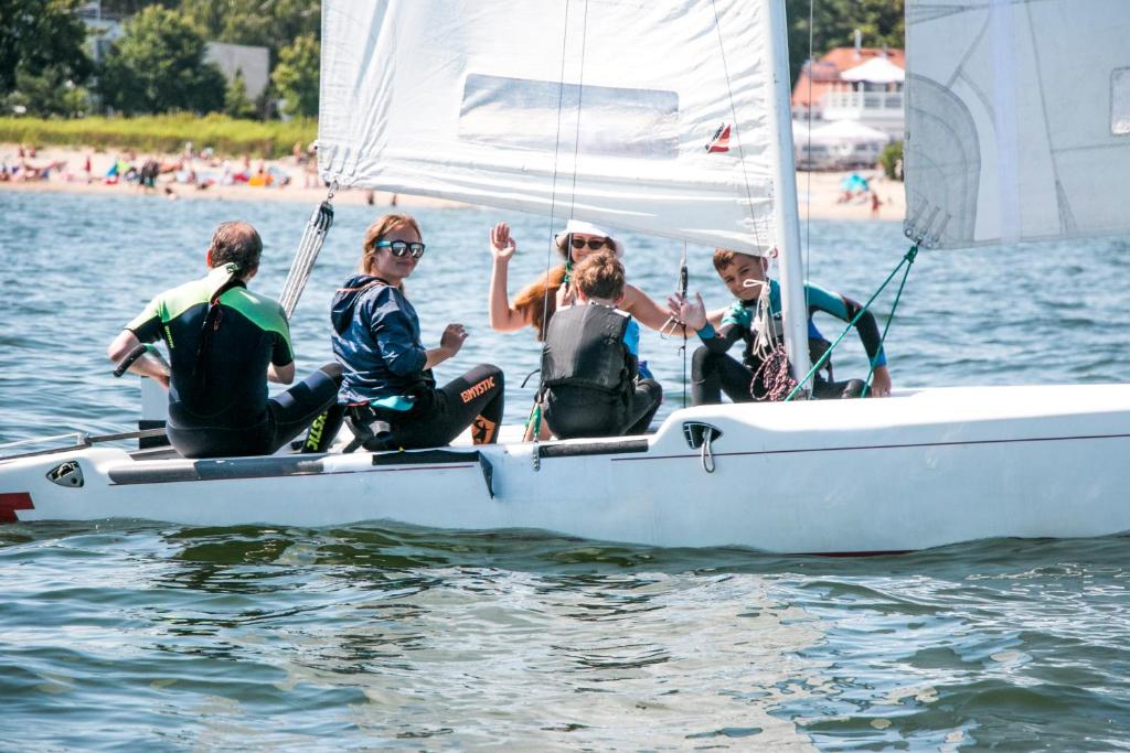 a group of people sitting on a sailboat in the water at Sopot 34 przy plaży in Sopot