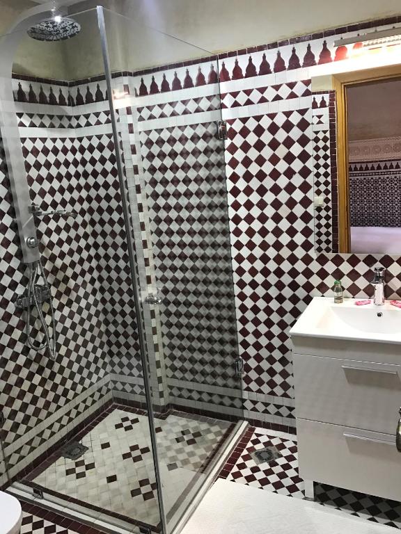 a bathroom with a shower and a sink at Riad Amor - Suite & Spa in Fès