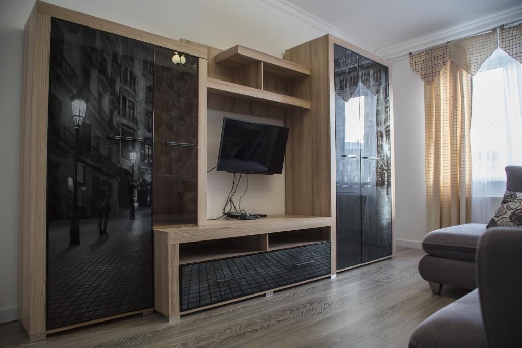 a living room with a tv on a wall at Apartamenty Lwow in Lviv