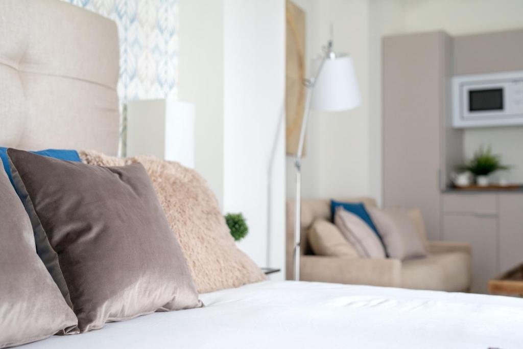 Posteľ alebo postele v izbe v ubytovaní Apartamentos Soho Boutique Museo