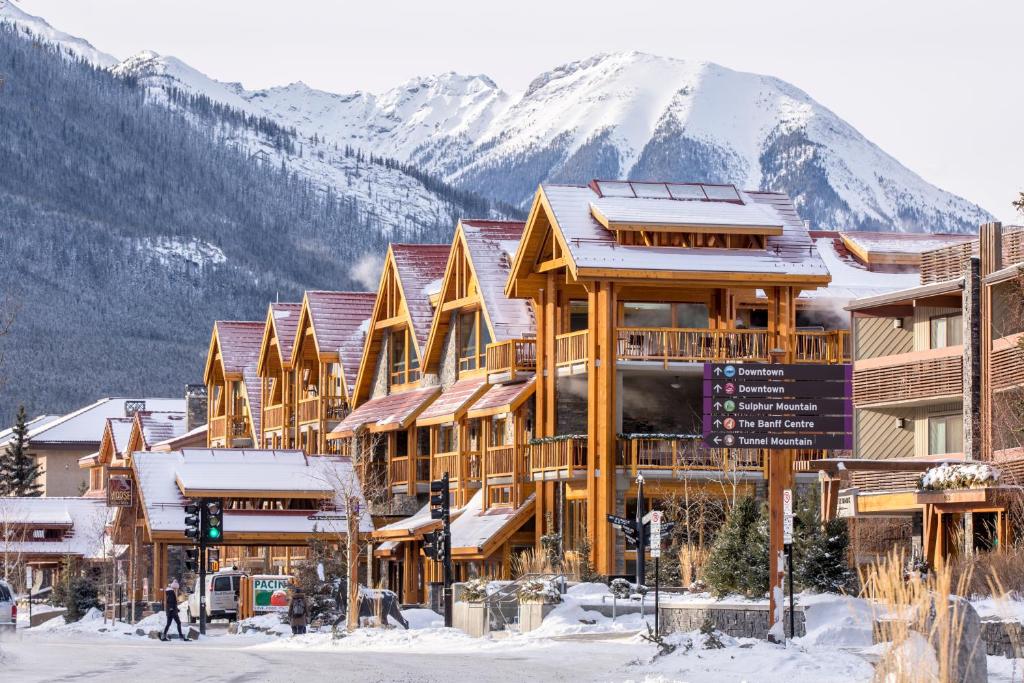 a ski lodge with a mountain in the background at Moose Hotel and Suites in Banff