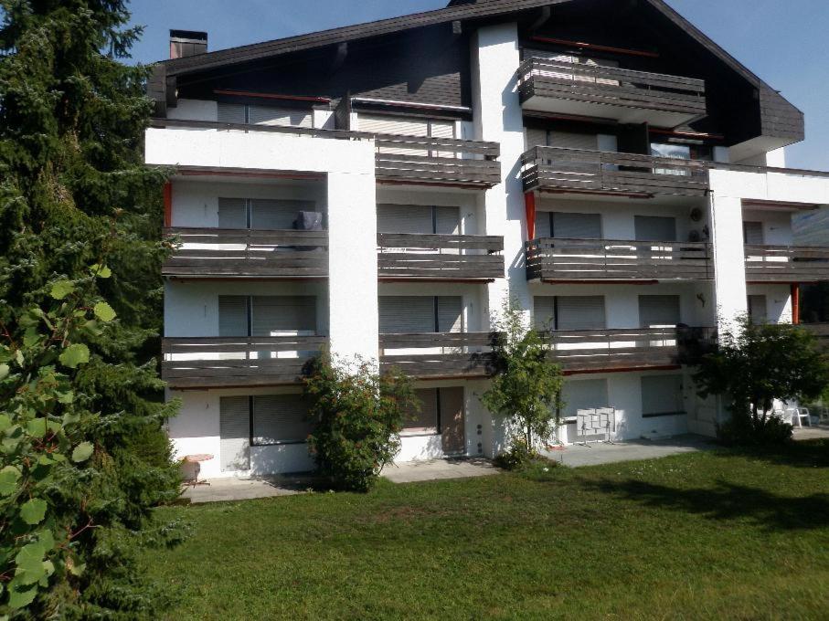 a large white building with a yard in front of it at Seegarten B (168 Be) in Lenzerheide