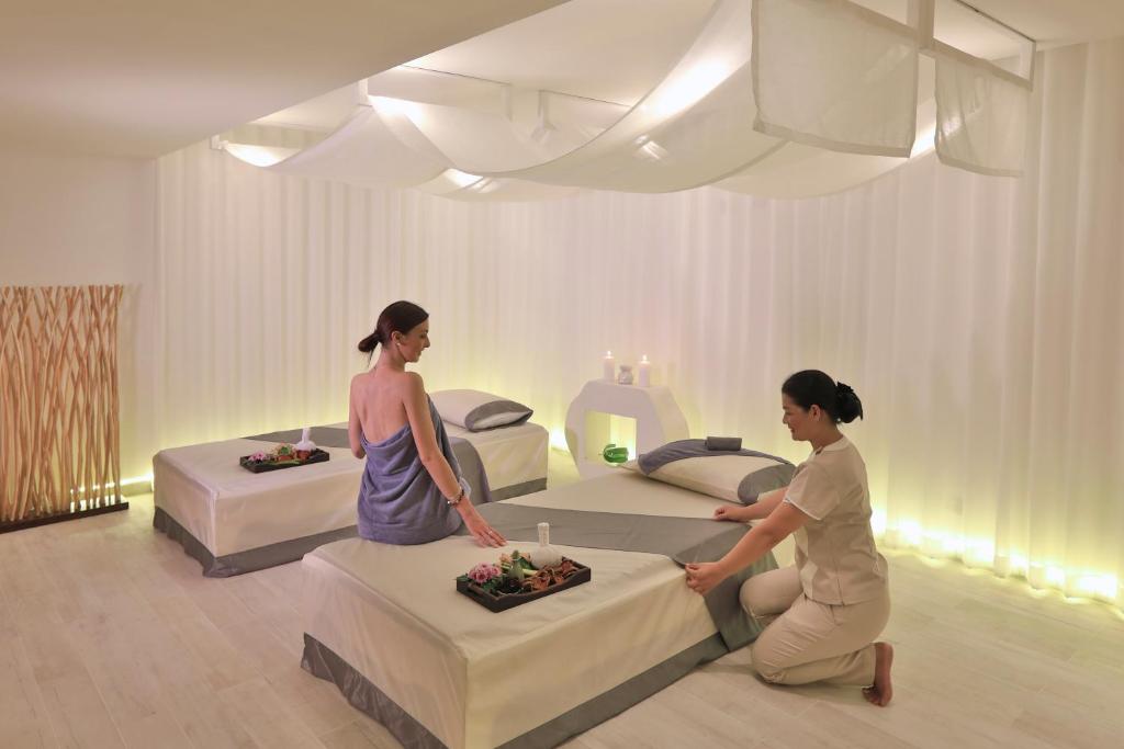two women in a room with two beds at Code Samui Hotel in Mae Nam
