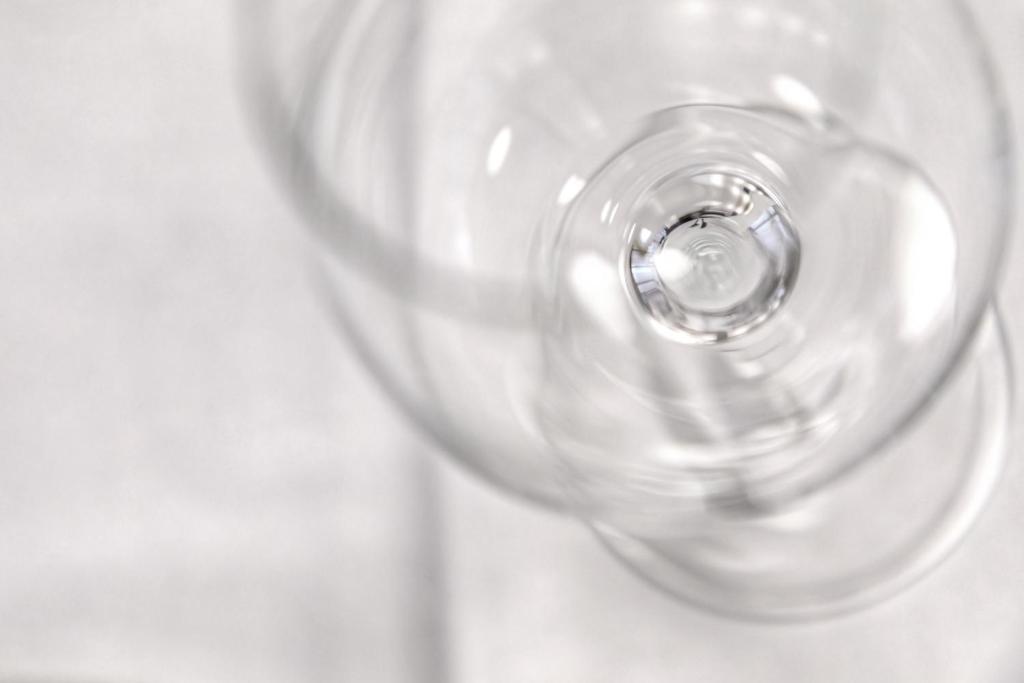 a clear wine glass sitting on top of a table at Hotel Energie in Prague