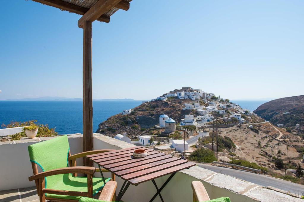 a table and chairs on a balcony with a view of a mountain at Agnanti Traditional in Kástron