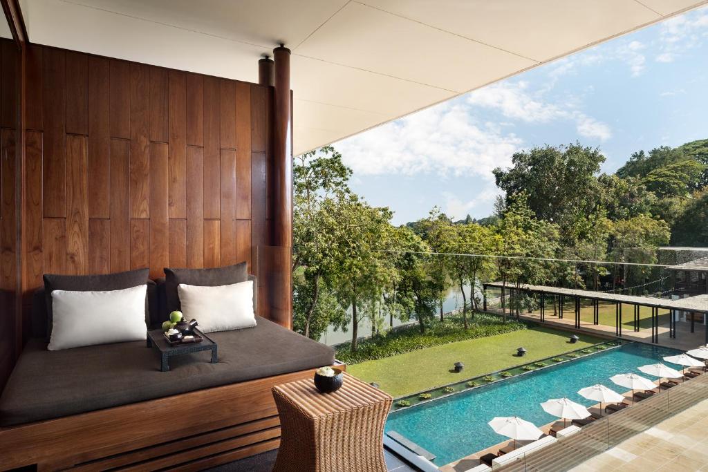 a bedroom with a view of a pool at Anantara Chiang Mai Resort in Chiang Mai