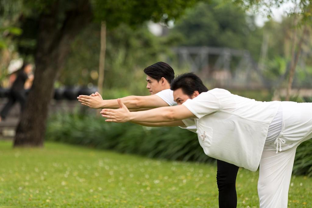 two men are playing a game of frisbee at Anantara Chiang Mai Resort in Chiang Mai