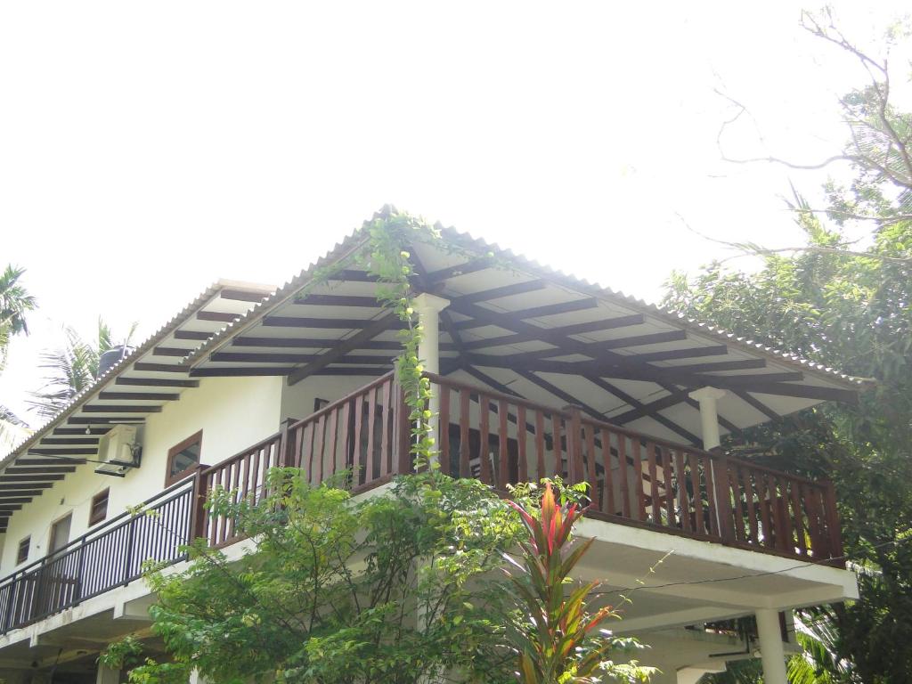 a house with a deck on top of it at Turtle Lamp in Unawatuna