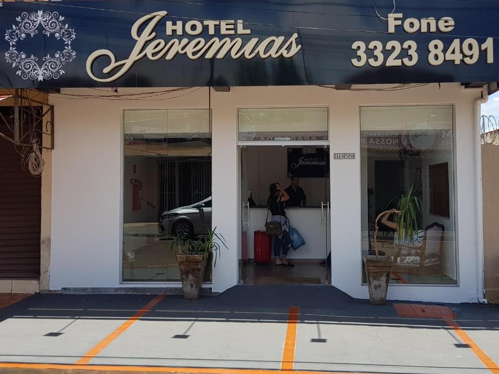 a store front of a hotel with a sign on it at Hotel Jeremias in Barretos