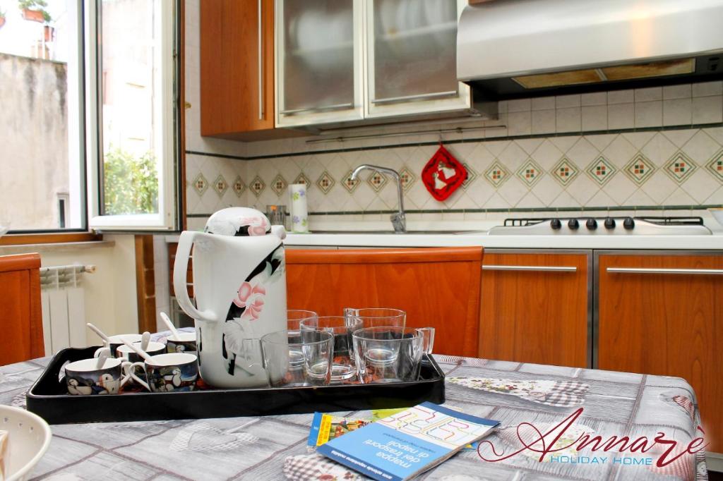 ナポリにあるAnnarè Home Holidayのキッチン(ティーポット、テーブル上のグラス付)