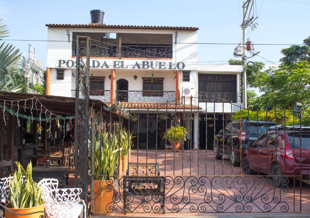 a building with a gate in front of it at Posada El Abuelo in Cúcuta